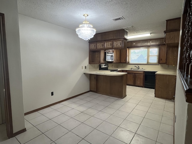 5013 57th St, Lubbock, TX 79414 - kitchen with stainless steel appliances, a peninsula, light countertops, a textured ceiling, and open shelves