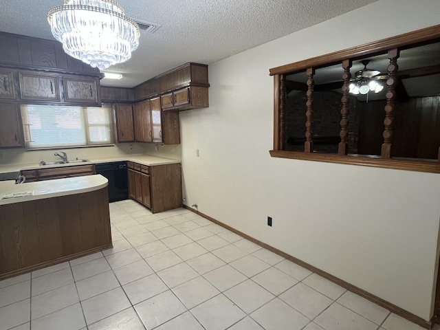 5013 57th St, Lubbock, TX 79414 - kitchen featuring black dishwasher, a textured ceiling, light countertops, a chandelier, and dark brown cabinets