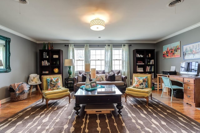 sitting room with hardwood / wood-style flooring and crown molding