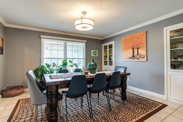 dining room featuring light tile patterned floors and crown molding