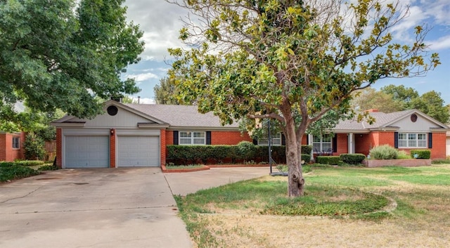 view of front of house featuring a garage and a front lawn