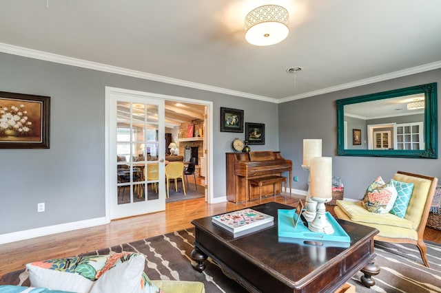 living room with hardwood / wood-style flooring and ornamental molding