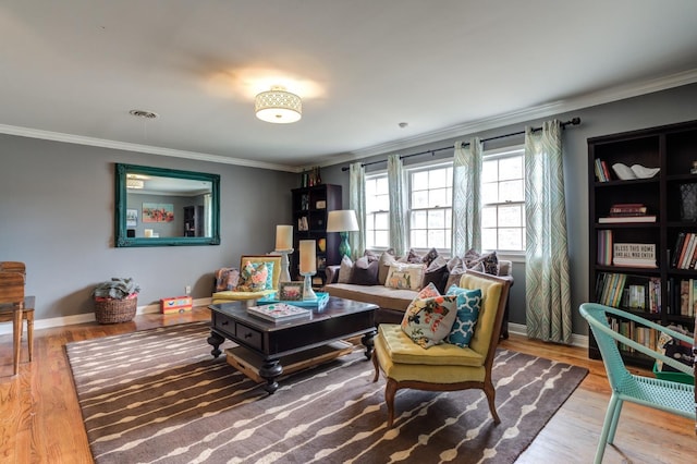 sitting room with crown molding and wood-type flooring