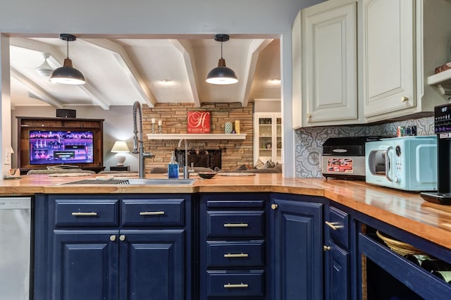 kitchen with hanging light fixtures, blue cabinets, and wood counters