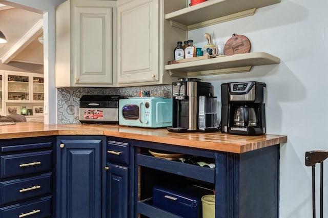 bar with blue cabinetry, white cabinets, and butcher block countertops