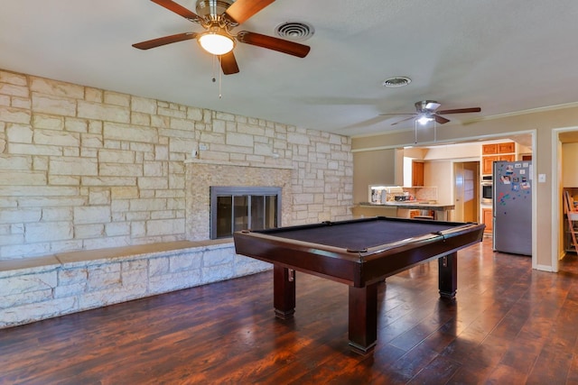 rec room featuring a stone fireplace, dark hardwood / wood-style floors, and billiards