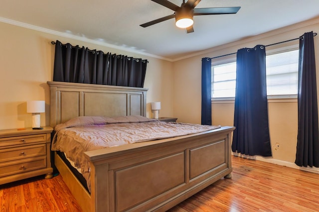 bedroom with ornamental molding, ceiling fan, and light wood-type flooring