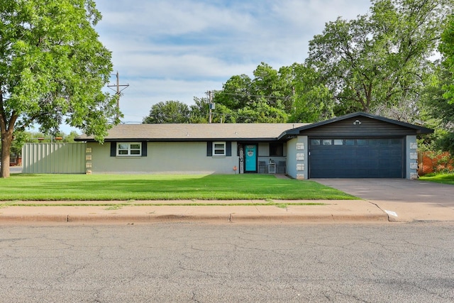 ranch-style home with a garage and a front lawn