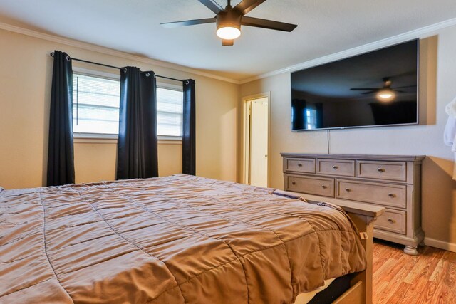 bedroom featuring light hardwood / wood-style flooring, ornamental molding, and ceiling fan