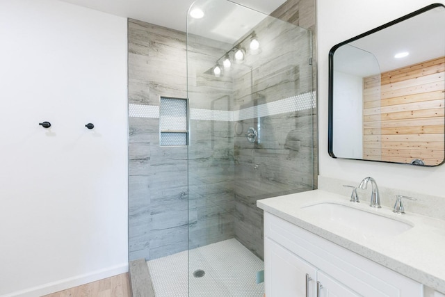 bathroom featuring vanity and a shower with shower door