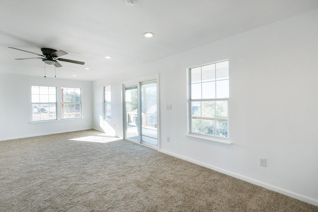 empty room with ceiling fan and carpet