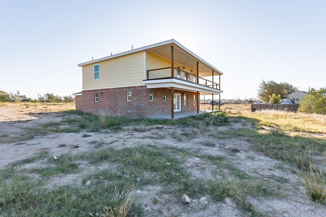 rear view of house featuring a balcony