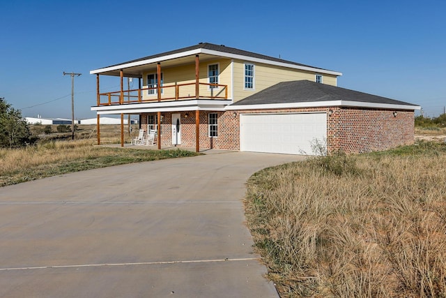 view of front of property with a garage and a balcony