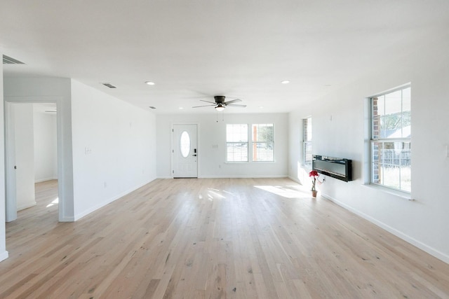 unfurnished living room featuring light hardwood / wood-style flooring and ceiling fan