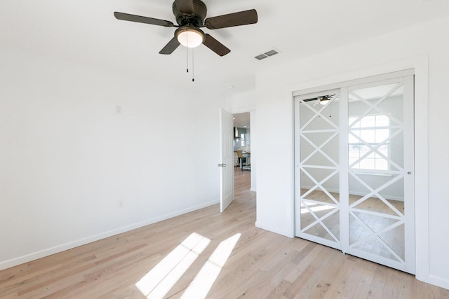 empty room featuring ceiling fan and light hardwood / wood-style flooring