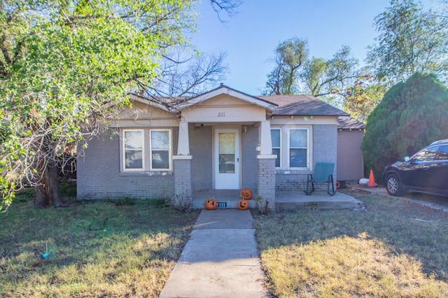 view of front of house featuring a patio and a front lawn