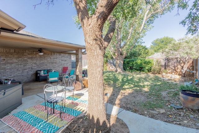 view of yard with ceiling fan and a patio