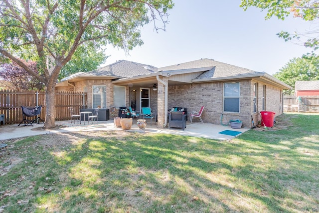 rear view of house with a patio and a lawn