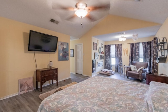 bedroom featuring ceiling fan, vaulted ceiling, and wood-type flooring