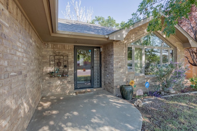 view of exterior entry featuring a patio area