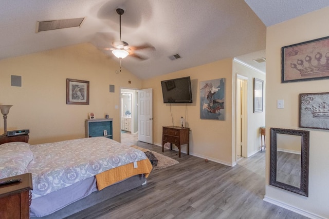 bedroom with hardwood / wood-style flooring, vaulted ceiling, and ceiling fan