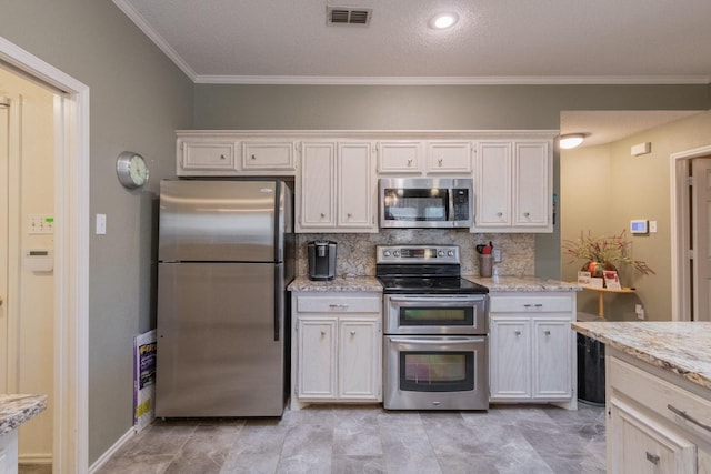 kitchen featuring white cabinetry, backsplash, ornamental molding, stainless steel appliances, and light stone countertops