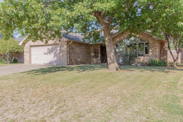 view of front of home with a garage and a front yard