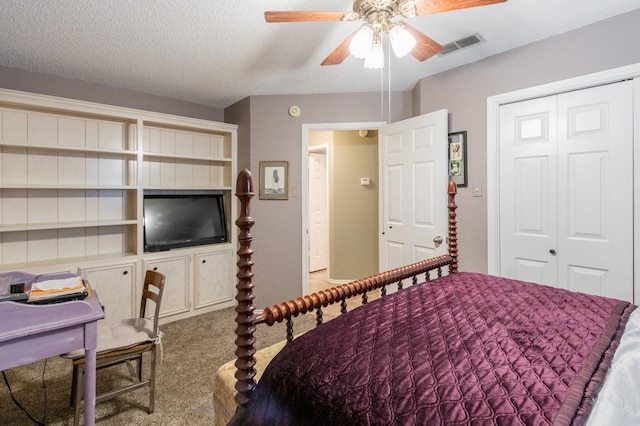 carpeted bedroom featuring ceiling fan, a closet, and a textured ceiling