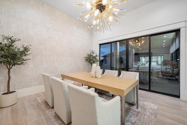 dining area with a notable chandelier and wood finished floors