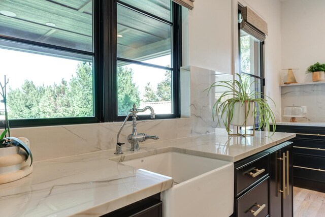 bedroom featuring multiple windows, access to exterior, and light hardwood / wood-style flooring