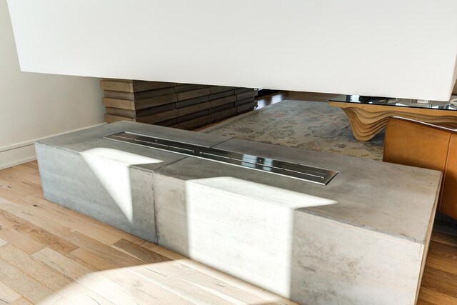 kitchen featuring tasteful backsplash, sink, light stone countertops, and light hardwood / wood-style floors