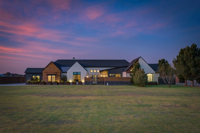 modern inspired farmhouse featuring a lawn