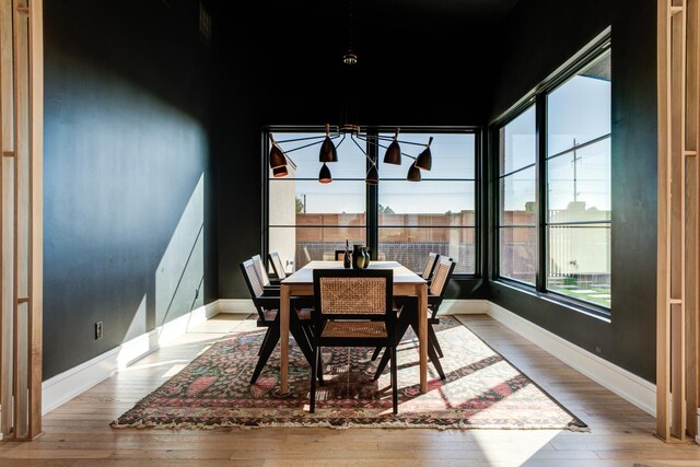 living room with a high ceiling and light hardwood / wood-style flooring