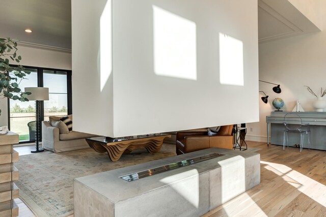 kitchen with light stone countertops, a breakfast bar, light hardwood / wood-style floors, and a kitchen island