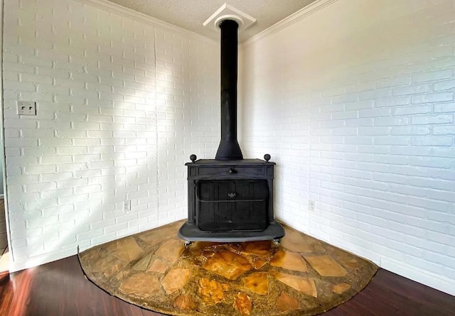 room details with crown molding, a textured ceiling, and a wood stove