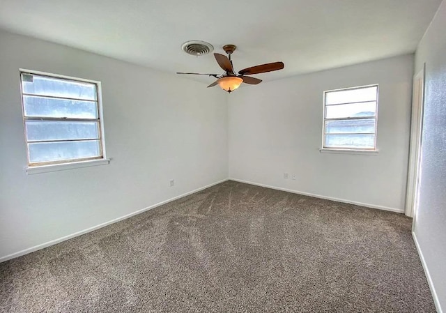 spare room featuring ceiling fan and carpet