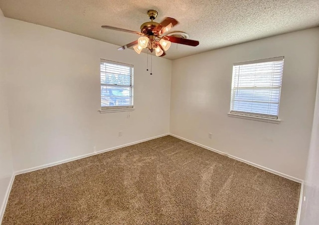 carpeted spare room with ceiling fan and a textured ceiling