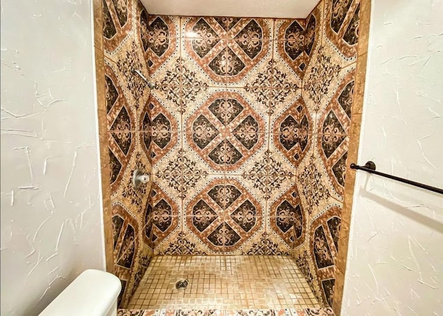 details with toilet and tiled shower