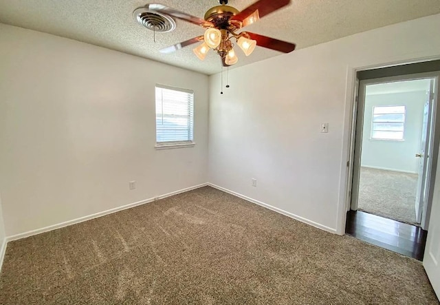 spare room with ceiling fan, carpet flooring, and a textured ceiling