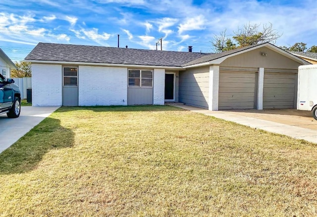 single story home with a garage and a front lawn