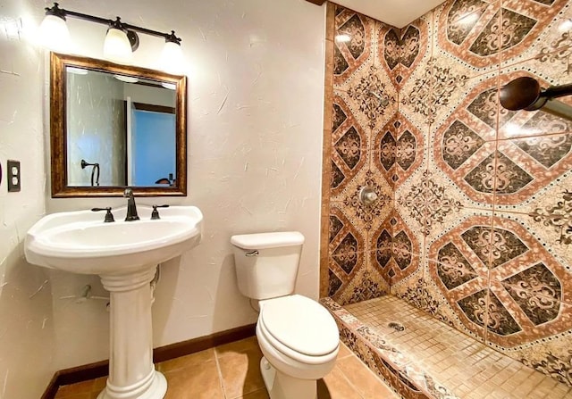 bathroom with tile patterned floors, toilet, and walk in shower