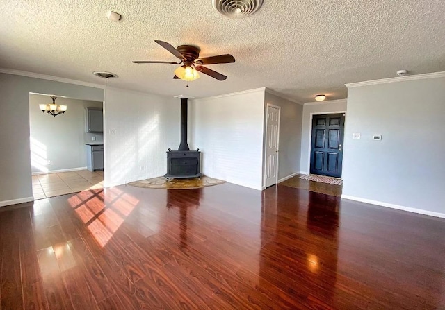 unfurnished living room featuring dark hardwood / wood-style flooring, a wood stove, crown molding, and a textured ceiling