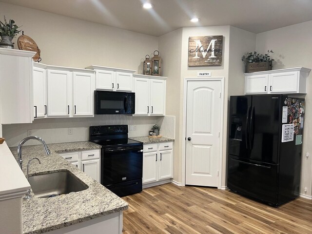 7022 34th Pl, Lubbock, TX 79407 - kitchen featuring black appliances, a sink, white cabinetry, light wood finished floors, and recessed lighting