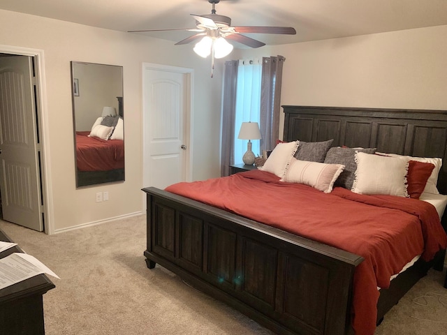 7022 34th Pl, Lubbock, TX 79407 - bedroom with light colored carpet, a ceiling fan, and baseboards