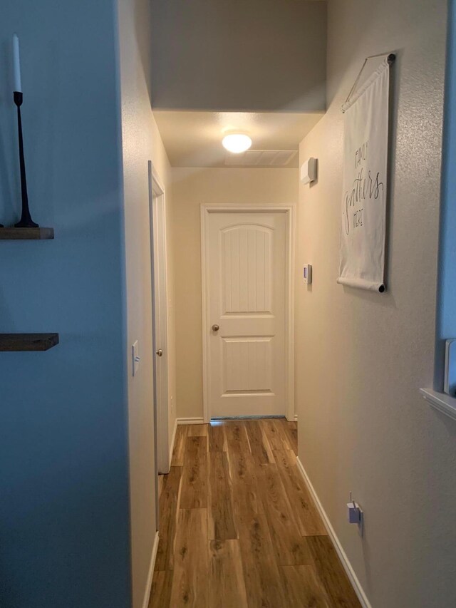 7022 34th Pl, Lubbock, TX 79407 - corridor featuring wood finished floors and baseboards