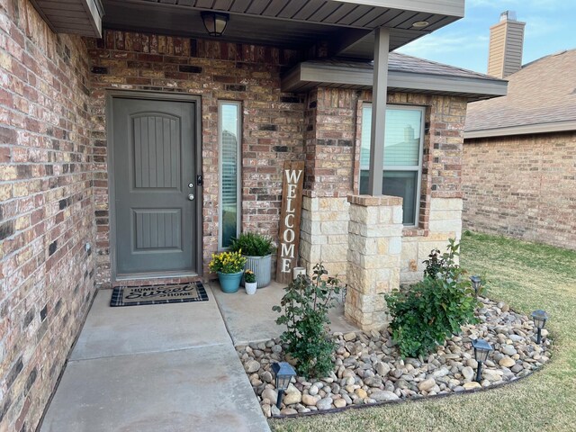 7022 34th Pl, Lubbock, TX 79407 - view of exterior entry featuring brick siding
