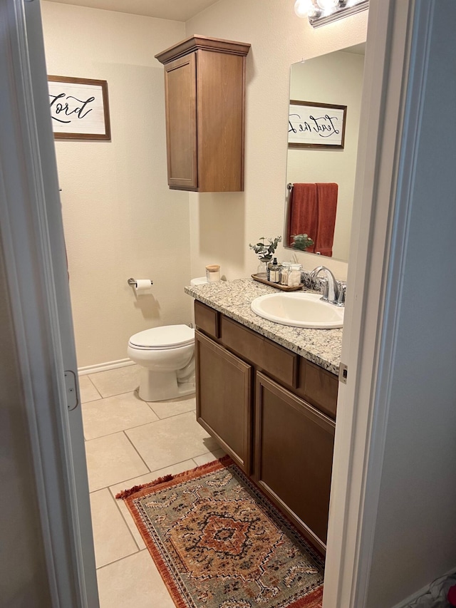 7022 34th Pl, Lubbock, TX 79407 - bathroom with tile patterned flooring, toilet, and vanity