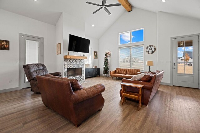 712 Cotton Creek Farms Cir, Tahoka, TX 79373 - living room with high vaulted ceiling, beamed ceiling, wood finished floors, a fireplace, and a ceiling fan