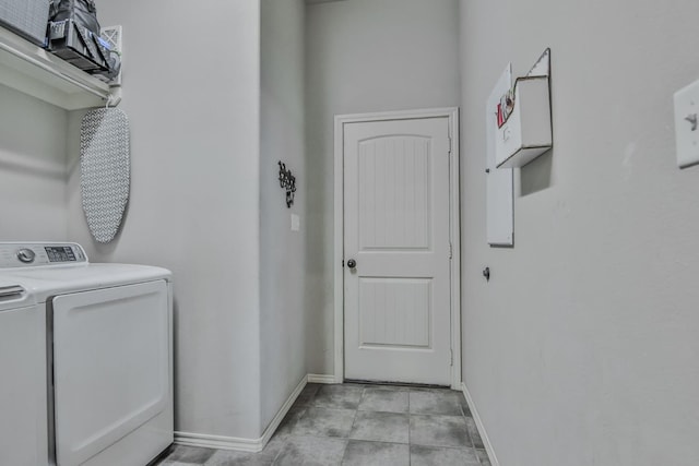 clothes washing area featuring washing machine and clothes dryer and light tile patterned floors