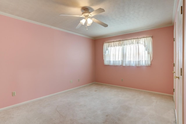 empty room with crown molding, light colored carpet, ceiling fan, and a textured ceiling